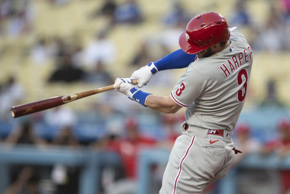 Philadelphia Phillies' Bryce Harper hits an RBI-single during the first inning of a baseball game against the Los Angeles Dodgers in Los Angeles, Monday, June 14, 2021. (AP Photo/Kyusung Gong)