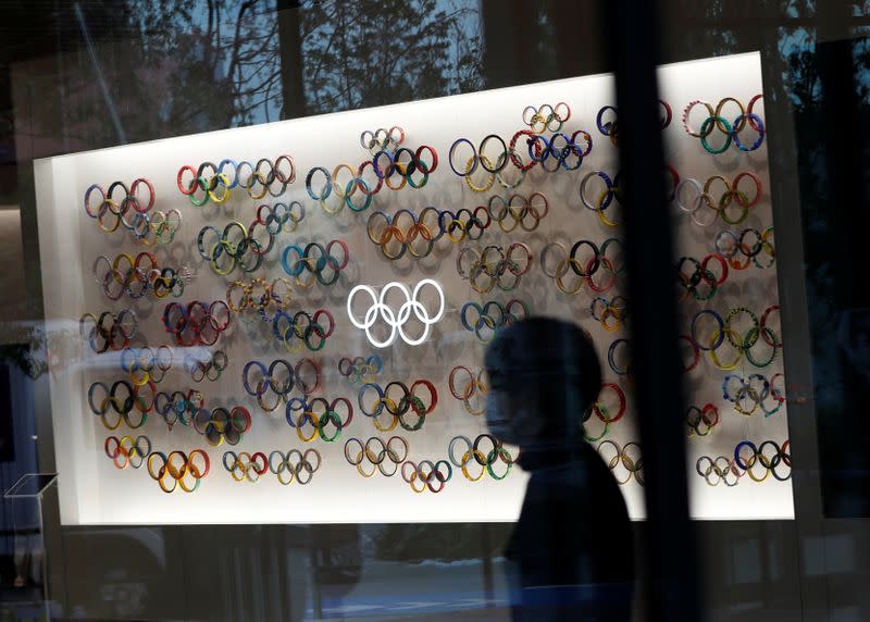 A woman wearing a protective face mask, following an outbreak of the coronavirus disease, is seen inside closed Japan Olympics Museum, in Tokyo, Japan