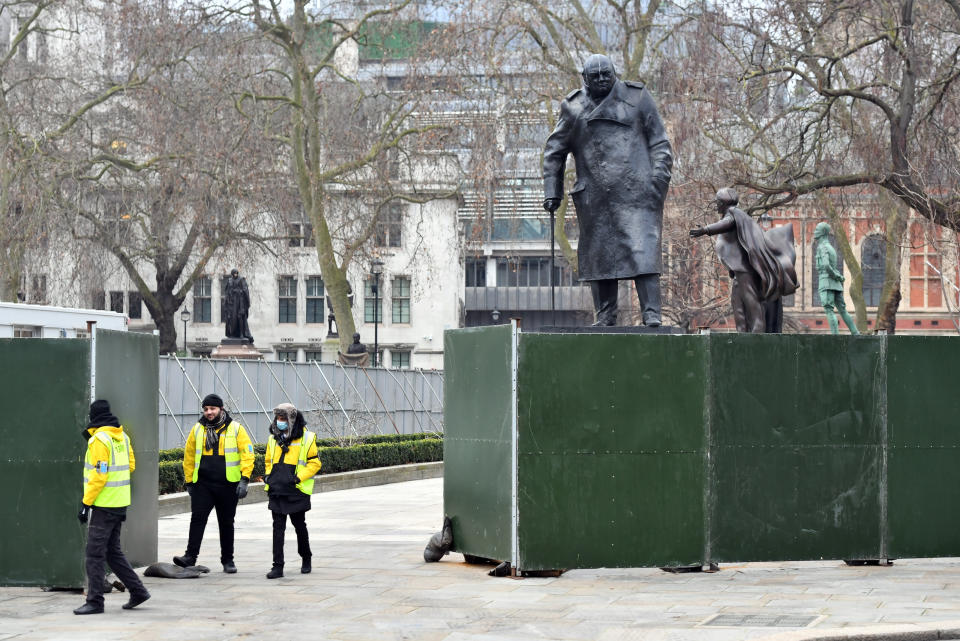 Fencing around the Winston Churchill statue in Parliament Square, London, ahead of New Year's Eve celebrations. People are being urged to stay home on New Year's Eve to prevent the "dire" situation in hospitals from getting worse. (Photo by Dominic Lipinski/PA Images via Getty Images)