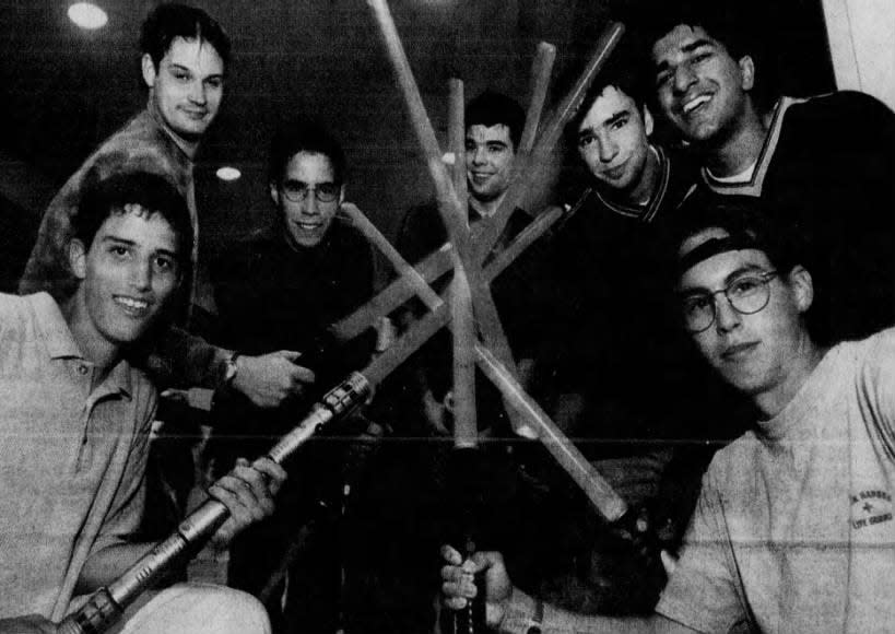 “Star Wars” fans, from left, Robert Fallone, Bill Greenhalgh, Todd Ruggini, Todd Dello-Russo, Steve Perlow, Raj Thind and Patrick Hosmer show off their light sabers while waiting Tuesday, May 18, 1999, at Bridgewater Commons for the premiere of “The Phantom Menace.”