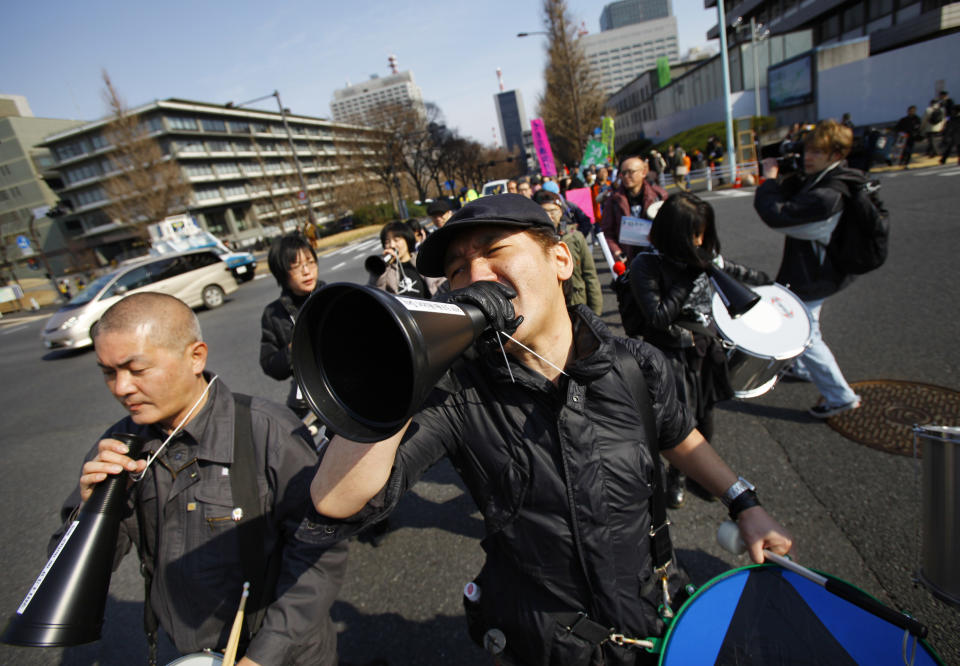 A protester beats a drum and shouts slogans during an anti-nuclear plant demonstration in Tokyo, Sunday, March 9, 2014. Banging on drums and waving "Sayonara nukes" signs, thousands of people rallied in a Tokyo park and marched to Parliament to demand an end to nuclear power ahead of the third anniversary of the Fukushima disaster. The demonstration Sunday is one of many such protests that have erupted since the March 11, 2011, nuclear disaster, the worst since Chernobyl. (AP Photo/Junji Kurokawa)