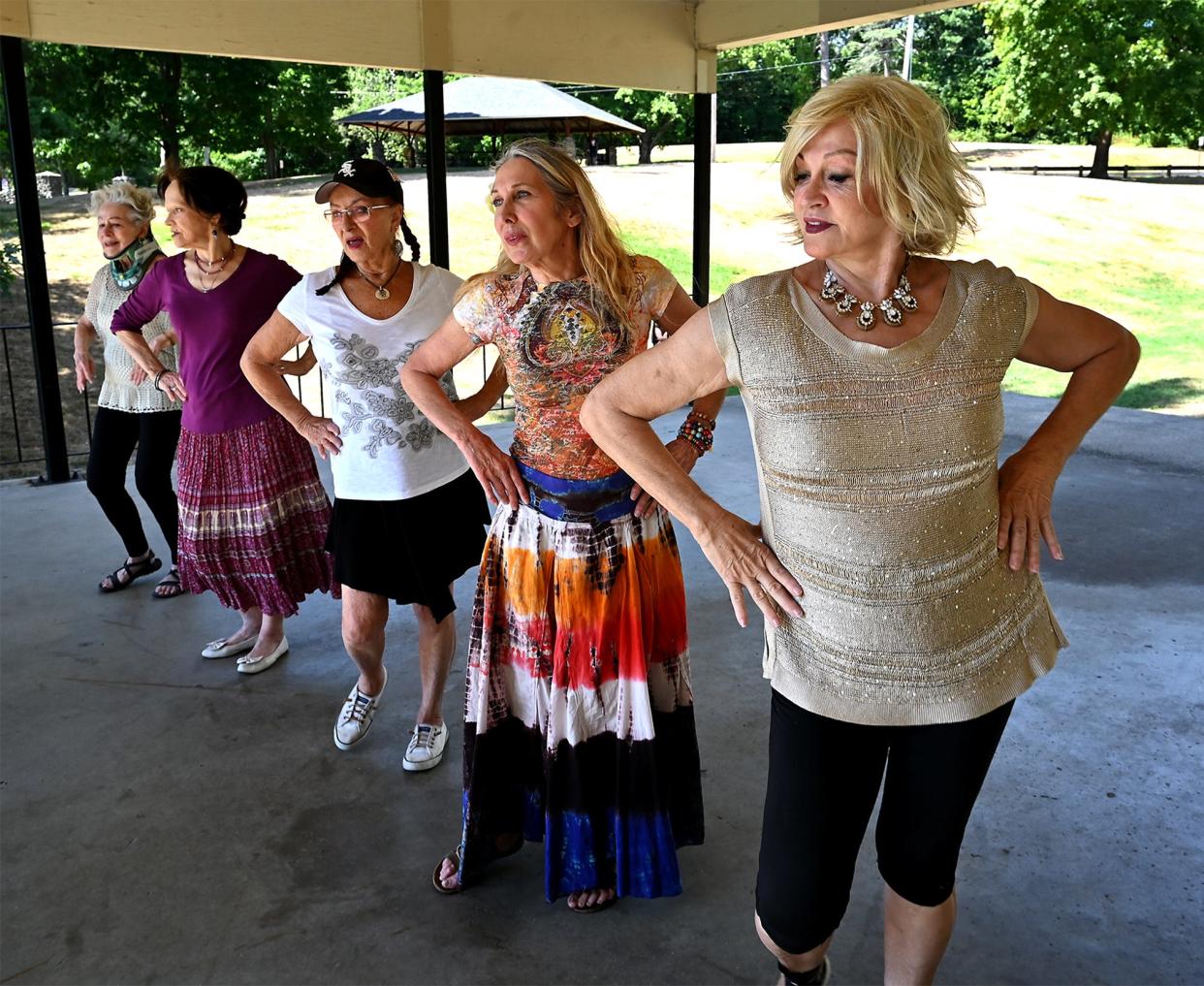 SHREWSBURY - Members of Silver Moon Gypsies practice their "gypsy fusion" style of dancing under a pavilion at Dean Park on Tuesday. Headed by Gypsy Phillips, 83, of Northborough, a dance instructor for 50 years, the "senior" group of ladies has been together for 12 years as they go out and perform for many health care and assisted living facilities or wherever they are requested. From right are Elaine Savoy, 78, of Millbury, Anna Connors, 68. of Shrewsbury, Gypsy Phillips, 83, of Northborough, Alida Krumin, 84, of Southborough and Norma Giumentaro, 89, of Shrewsbury.