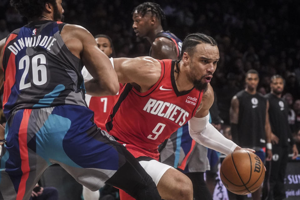 Houston Rockets' Dillon Brooks, right, drives to the basket past Brooklyn Nets' Spencer Dinwiddie during the first half of an NBA basketball game Saturday, Jan. 27, 2024, in New York. (AP Photo/Bebeto Matthews)