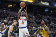 New York Knicks' Immanuel Quickley (5) shoots against Indiana Pacers' Kelan Martin (21) during the first half of an NBA basketball game Wednesday, Dec. 8, 2021, in Indianapolis. (AP Photo/Darron Cummings)