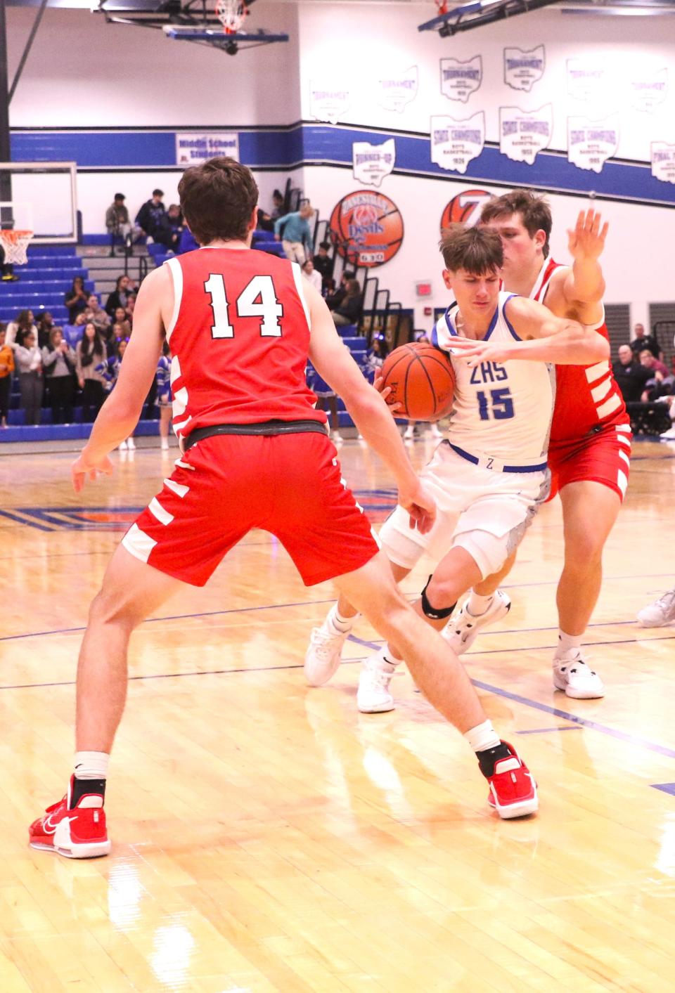 Zanesville's Maddox Hayes tries to get past a Johnstown defender and fellow Johnnie, Kyle Siegfried (14), as the Blue Devils won 53-45 on Wednesday.