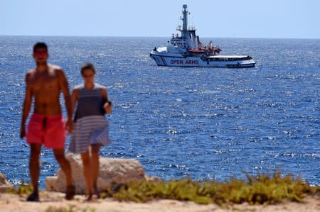 Spanish migrant rescue ship Open Arms is seen close to the Italian shore in Lampedusa