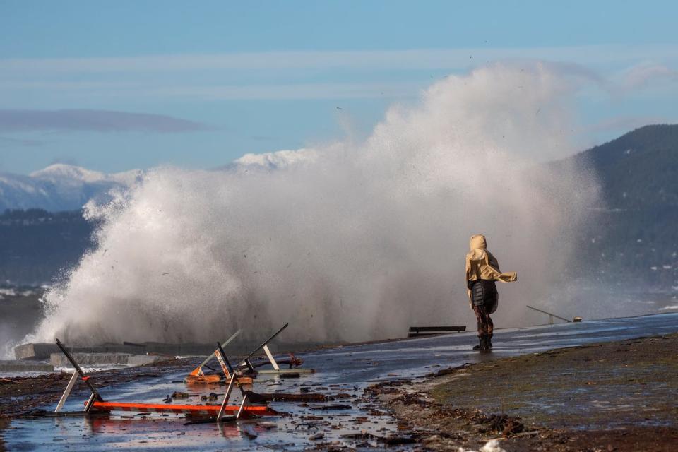 Waves are pictured crashing into the seawall in English Bay during a king tide in Vancouver, British Columbia on Friday, Jan. 7, 2022. 