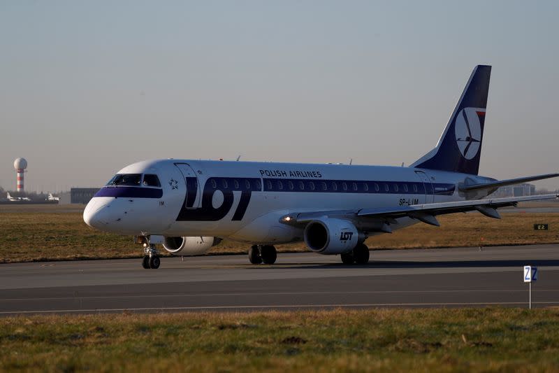 FILE PHOTO: LOT Polish Airlines Embraer ERJ-175LR aircraft taxis to runway at the Chopin International Airport in Warsaw