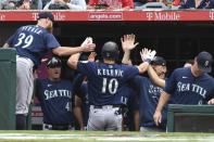 Seattle Mariners' Jarred Kelenic (10) is congratulated in the dugout after hitting a solo home run in the seventh inning of a baseball game against the Seattle Mariners, Sunday, Sept. 26, 2021, in Anaheim, Calif. (AP Photo/Michael Owen Baker)