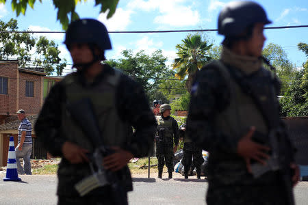 Soldiers stand at a check point as they guard the city after the Honduras government enforced a curfew on Saturday while still mired in chaos over a contested presidential election that has triggered looting and protests in Tegucigalpa, Honduras December 2, 2017. REUTERS/ Jorge Cabrera