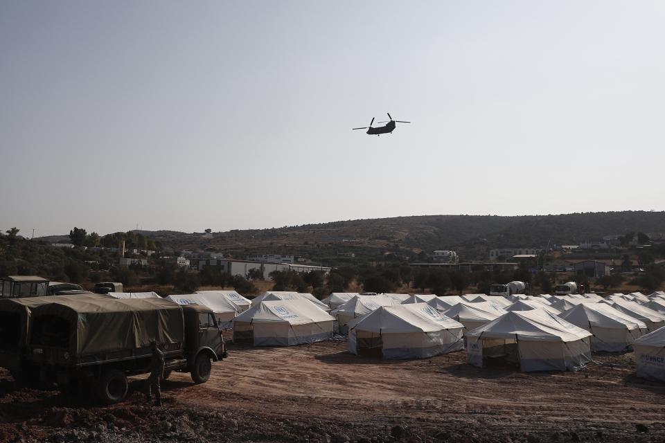 A Greek Army helicopter carrying the European Council President Charles Michel flies over the new temporary refugee camp in Kara Tepe on the northeastern island of Lesbos, Greece, Tuesday, Sept. 15, 2020. Greece has called on the European Union to jointly run new refugee camps being built on its eastern islands as part of a planned overhaul of the bloc's migration policy. (Dimitris Tosidis/Pool via AP)