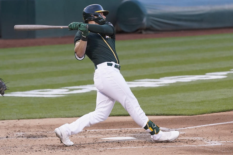 Oakland Athletics' Seth Brown hits a two-run home run against the Kansas City Royals during the fourth inning of a baseball game in Oakland, Calif., Friday, June 11, 2021. (AP Photo/Jeff Chiu)