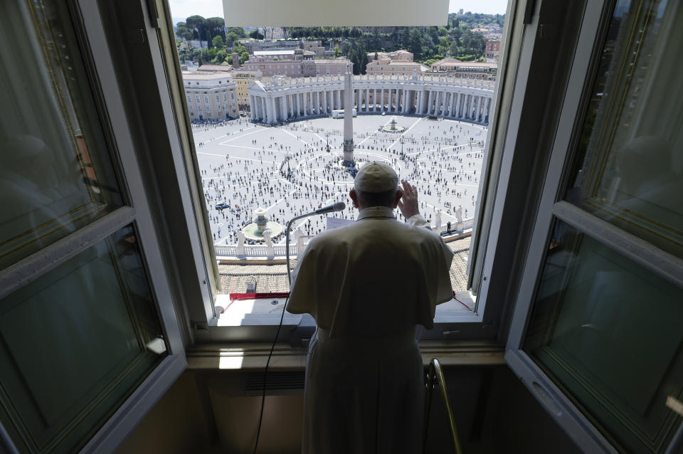 Pope Francis delivers his blessing from his studio window overlooking St. Peter's Square at the Vatican, Sunday, May 31, 2020. Francis celebrated a Pentecost Mass in St. Peter's Basilica on Sunday, albeit without members of the public in attendance. He will then went to his studio window to recite his blessing at noon to the crowds below. The Vatican says police will ensure the faithful gathered in the piazza keep an appropriate distance apart. (Vatican News via AP)