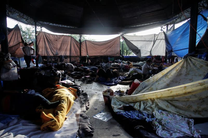 Asylum-seeking migrants, who were apprehended and returned to Mexico under Title 42 after crossing the border from Mexico into the U.S., rest in a public square where hundreds of migrants live in tents, in Reynosa