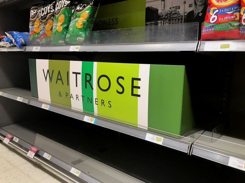 Empty crisp shelves are pictured at Waitrose supermarket, in Canary Wharf