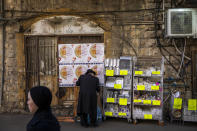 An ultra-Orthodox Jewish man buys disposable plastic dishes in Jerusalem's Mea Shearim neighborhood, Friday, Jan. 20, 2023. Israel's new government is in the process of repealing a new tax on single-use plastics. Ultra-Orthodox Jews, who have large families and use large quantities of disposable cups, plates and cutlery, say the tax unfairly targeted them. (AP Photo/Oded Balilty)