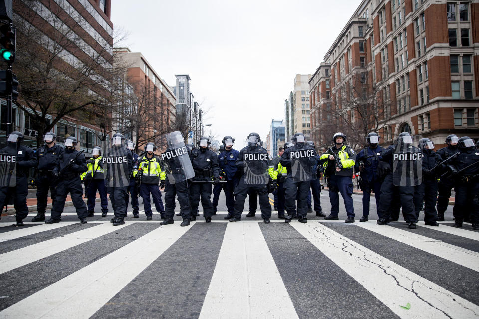 Police officers in riot gear stand lined up during a demonstration in Washington, D.C., after January's inauguration. (Photo: Bloomberg via Getty Images)