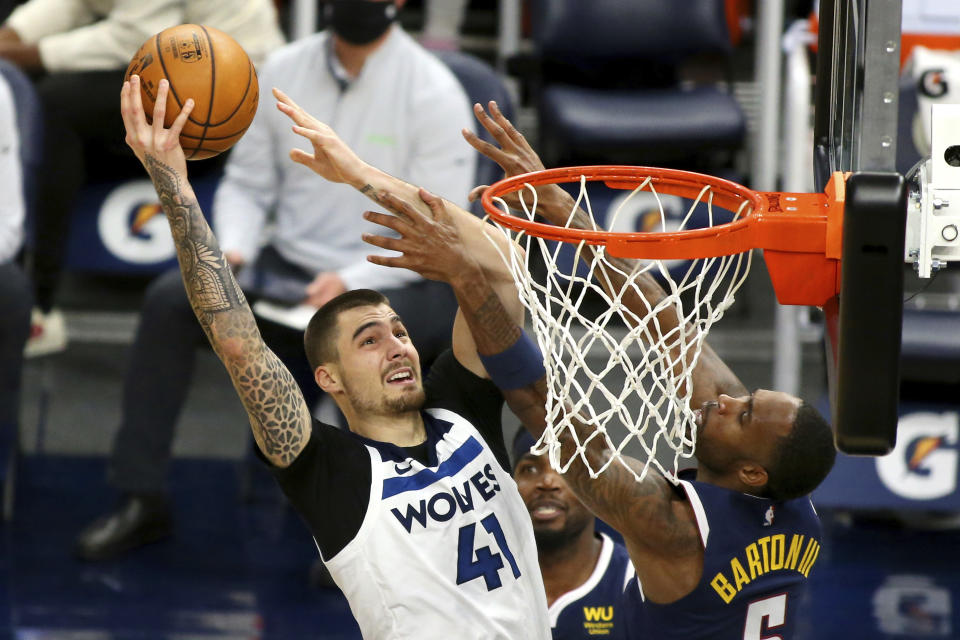Minnesota Timberwolves forward Juancho Hernangomez (41) shoots against Denver Nuggets guard Will Barton in the second quarter during an NBA basketball game, Sunday, Jan. 3, 2021, in Minneapolis. (AP Photo/Andy Clayton-King)