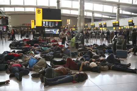 Climate activist group Reclaim the Power lie on the ground during a protest against airport expansion plans at Heathrow Airport in London, Britain October 1, 2016. REUTERS/Neil Hall