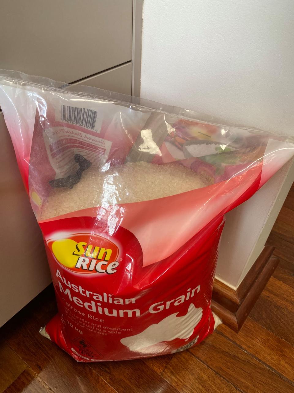 A sealed bag of Sunrice Australian Medium Grain rice with a butterfly inside. 