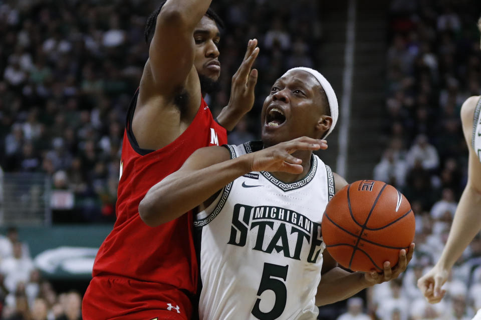 Michigan State guard Cassius Winston (5) drives on Maryland forward Donta Scott (24) in the second half of an NCAA college basketball game in East Lansing, Mich., Saturday, Feb. 15, 2020. (AP Photo/Paul Sancya)