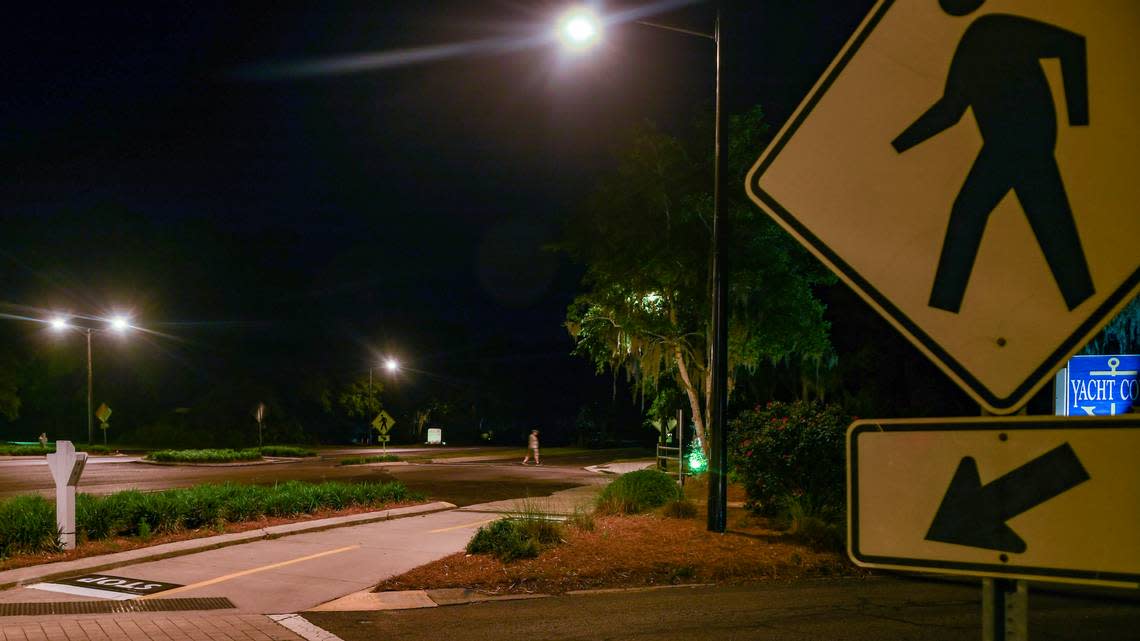 Photographed with a long exposure, a pedestrian crosses U.S. 278 near Yacht Cove Drive on May 1, 2023, on Hilton Head Island. The lights were installed in October 2020 as a pilot project for street lighting after 11-year-old islander Charli Bobinchuck died while crossing U.S. 278 with her dog, Max, in June 2018.