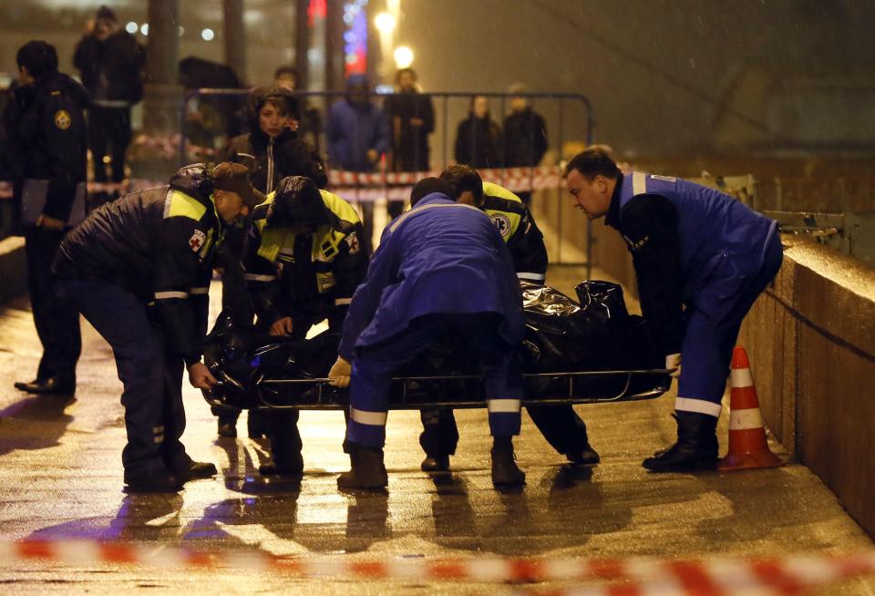 Medics lift the body of Boris Nemtsov, who was shot dead, in central Moscow February 28, 2015. Nemtsov, a Russian opposition politician and former deputy prime minister who was an outspoken critic of President Vladimir Putin, was shot dead metres from the Kremlin in central Moscow late on Friday. (REUTERS/Maxim Shemetov)