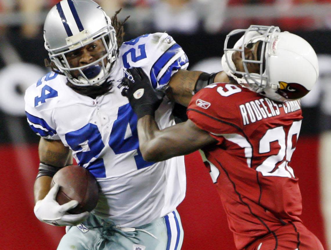 Dallas RB Marion Barber stiff-arms Cardinals defender Dominique Rodgers-Cromartie on a fourth-quarter run during the Arizona Cardinals vs. the Dallas Cowboys NFL football game at in December 2010. (Fuyang DeLuca/The Dallas Morning News)