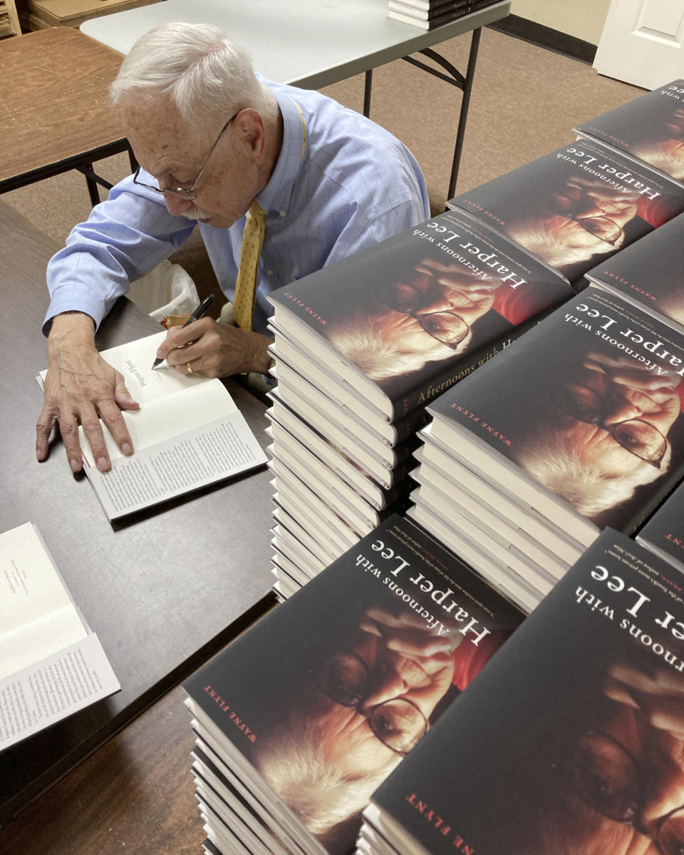 Alabama historian Wayne Flynt signs a copy of his new book, "Afternoons with Harper Lee," about the late author of "To Kill a Mockingbird," at a book-signing in Homewood, Ala., on Thursday, Sept. 22, 2022. Flynt and his late wife were friends with Lee, who died in 2016. (AP Photo/Jay Reeves)