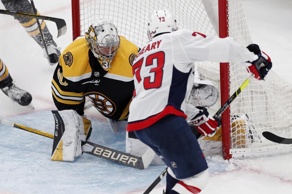 Washington Capitals' Conor Sheary, right, scores on Boston Bruins' Dan Vladar, left, during the second period of an NHL hockey game, Sunday, April 11, 2021, in Boston. (AP Photo/Michael Dwyer)