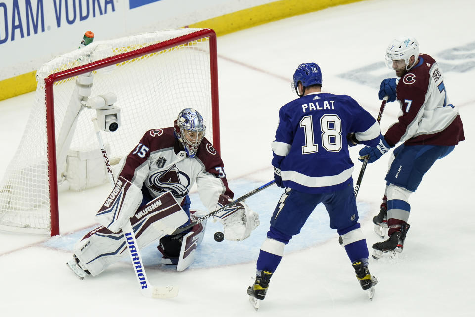 Colorado Avalanche goaltender Darcy Kuemper (35) makes a save on a shot from Tampa Bay Lightning left wing Ondrej Palat (18) during the first period of Game 3 of the NHL hockey Stanley Cup Final on Monday, June 20, 2022, in Tampa, Fla. (AP Photo/Chris O'Meara)