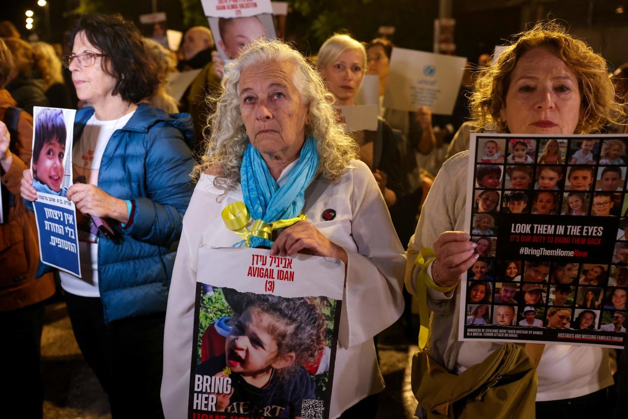 A woman holds a portrait of Avigail Idan, 3, as protesters lift placards during a rally outside the Unicef offices in Tel Aviv on November 20, 2023 to demand the release of Israelis held hostage in Gaza since the October 7 attack by Hamas militants, amid ongoing battles between Israel and the Palestinian armed group. (Photo by AHMAD GHARABLI / AFP) (Photo by AHMAD GHARABLI/AFP via Getty Images) ORIG FILE ID: AFP_34488MZ.jpg