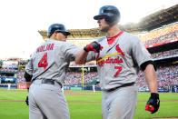 Matt Holliday #7 of the St. Louis Cardinals celebrates with Yadier Molina #4 after hitting a solo home run in the sixth inning against the Atlanta Braves during the National League Wild Card playoff game at Turner Field on October 5, 2012 in Atlanta, Georgia. (Photo by Scott Cunningham/Getty Images)