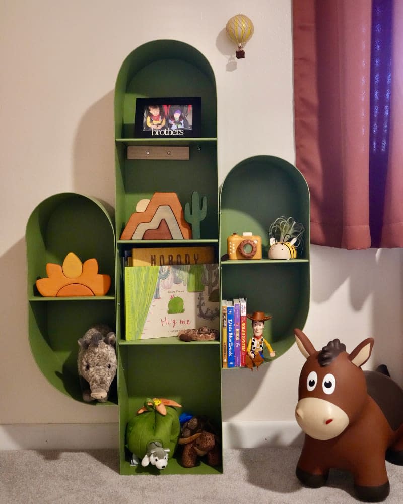 Cactus themed shelf in guest room.