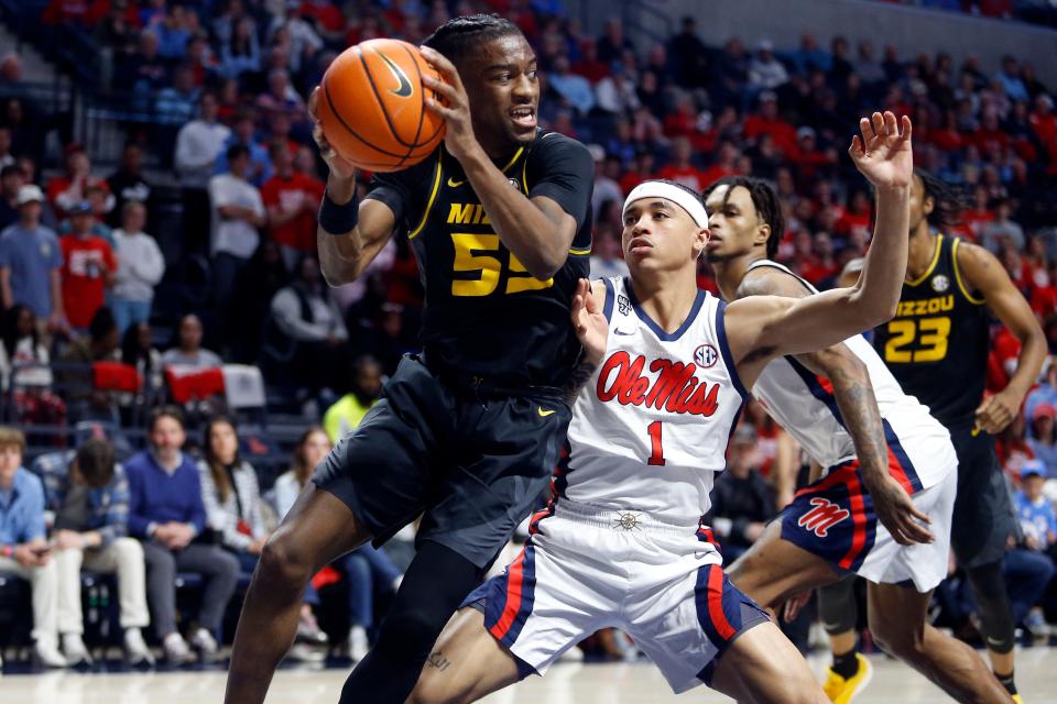 Feb 17, 2024; Oxford, Mississippi, USA; Missouri Tigers guard Sean East II (55) drives to the basket as Mississippi Rebels guard Austin Nunez (1) defends during the first half at The Sandy and John Black Pavilion at Ole Miss. Mandatory Credit: Petre Thomas-USA TODAY Sports