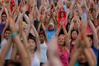 <p>People participate in a yoga class during an annual Solstice event in the Times Square district of New York, June 21, 2017. (Photo: Lucas Jackson/Reuters) </p>