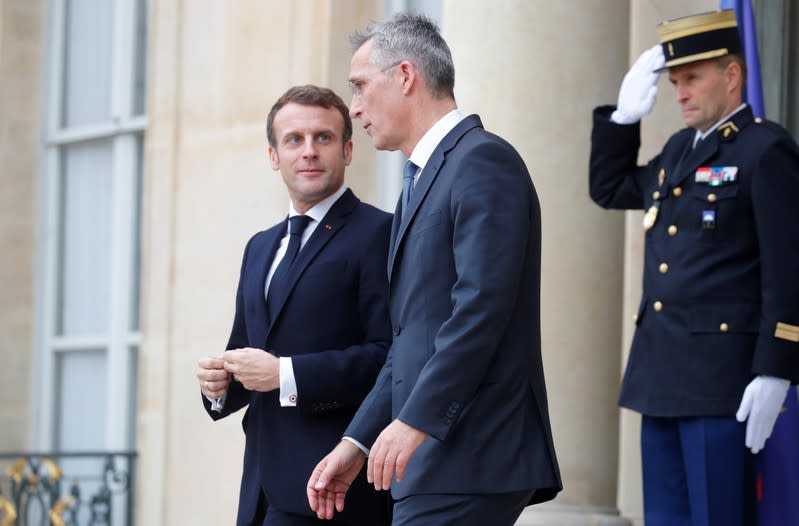 French President Emmanuel Macron and NATO Secretary General Jens Stoltenberg leave after a meeting at the Elysee Palace in Paris