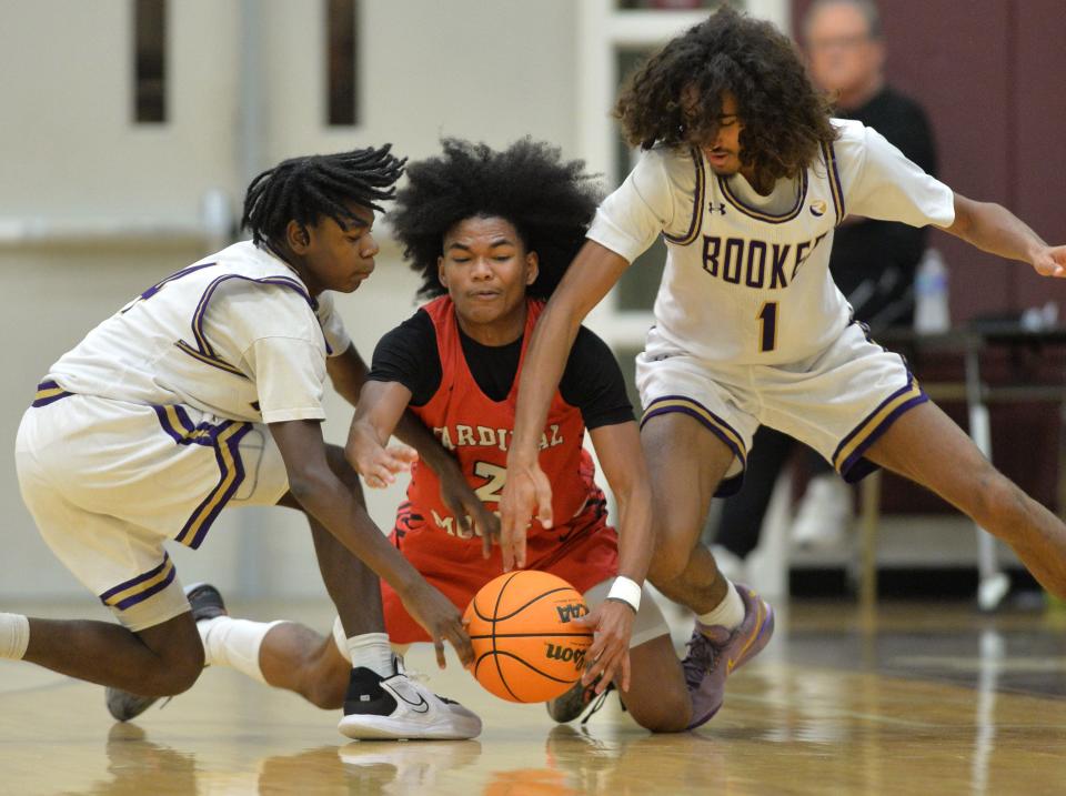 Cardinal Mooney's Sean Scurry (#2) battles for a loose ball against Booker High's Trey Stanford (#4) and Jovan Palavra (#1). Riverview High School hosted the 32nd annual Ram Jam holiday basketball tournament this week, featuring eight teams playing over three days, concluding with the final game Friday night.