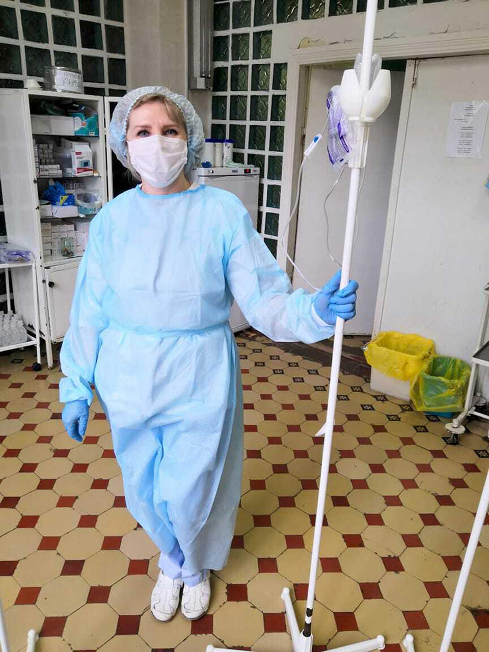 In this photo taken on April 13, 2020, and provided by Nina Rogova, Nina Rogova, a nurse at a local hospital, poses for a photo in Karabanovo, Vladimir region 200 kilometers (120 miles) east of Moscow, Russia, Wednesday, May 20, 2020. Rogova and her colleagues lived in their hospital ward for six days as it was locked down for quarantine after one of the patients tested positive for the virus. Rogova, who is now recovering after contracting the virus at work, complained about shortages of protective gear to local media and now fears for her job. (Courtesy of Nina Rogova via AP)