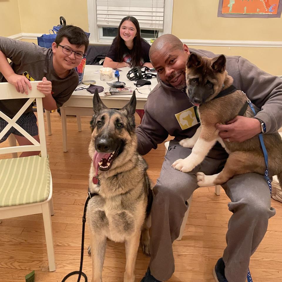 CARE founder James Evans smiles at home with his children, Andrew, 11, and Lila, 13, and their beloved rescue dogs, Guapo, 3, and Rocky, 4 months. The family was rejected for dog adoption by rescue organizations a dozen times before a colleague connected them with Rocky. (Courtesy Companions and Animals for Reform and Equity (CARE))