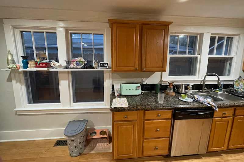 Wooden cabinets in kitchen before renovation.