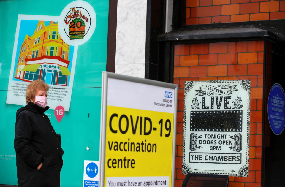 A woman queues to receive the coronavirus disease (COVID-19) vaccine outside a closed down Debenhams store that is being used as a vaccination centre in Folkestone, Kent, Britain January 28, 2021. REUTERS/Andrew Couldridge