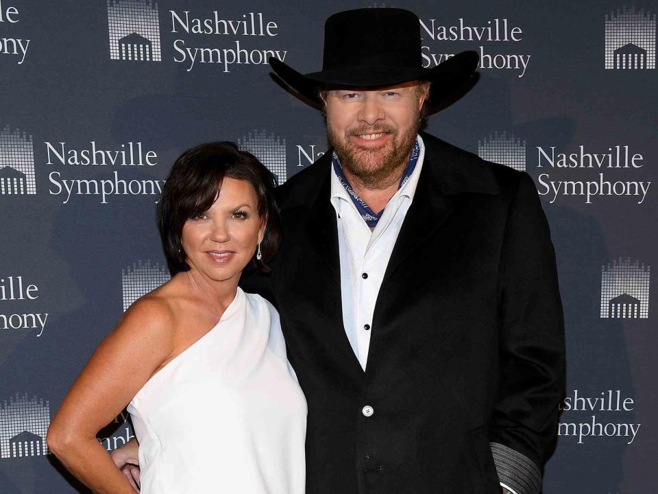 <p>Jason Kempin/Getty </p> Tricia Lucus and Toby Keith.