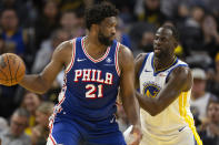 Philadelphia 76ers center Joel Embiid (21) looks to pass around Golden State Warriors forward Draymond Green (23) during the second half of an NBA basketball game, Tuesday, Jan. 30, 2024, in San Francisco. (AP Photo/D. Ross Cameron)