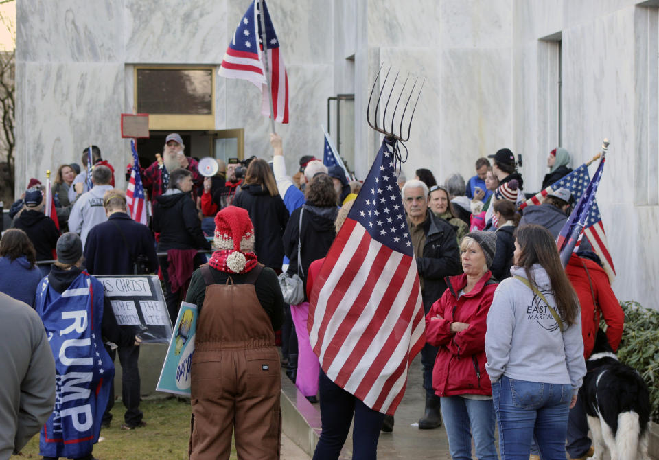 CORRECTS SPELLING TO SELSKY NOT SELSKI Pro-Trump and anti-mask demonstrators hold a rally outside the Oregon State Capitol on Monday, Dec. 21, 2020, as legislators meet for an emergency session. (AP Photo/Andrew Selsky)