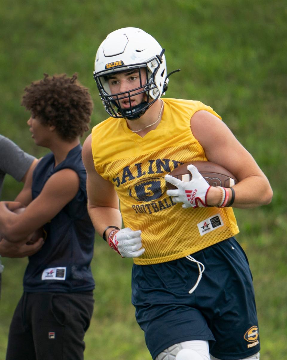 Saline tight end Tyler Mesman catches a pass  during practice at Saline High School on Monday, Aug. 7, 2023.