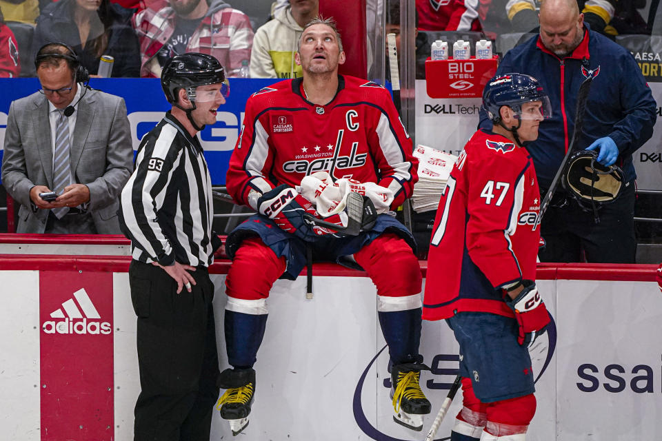 Washington Capitals left wing Alex Ovechkin (8) sits on the boards during a timeout in the third period of the team's NHL hockey game against the Pittsburgh Penguins, Friday, Oct. 13, 2023, in Washington. The Penguins won 4-0. (AP Photo/Andrew Harnik)