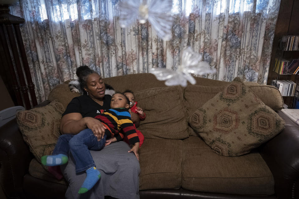 Shelonda Lyons looks after her grandchildren, Malik Lyons-Law, center, and Adrien Lyons, on Saturday, Feb. 5, 2022, in Birmingham, Ala. Shelonda always taught both her daughters the bitter truth of racism, hoping it would prepare them to navigate life growing up in Birmingham, the Deep South city known for its place in civil rights history. (AP Photo/Wong Maye-E)