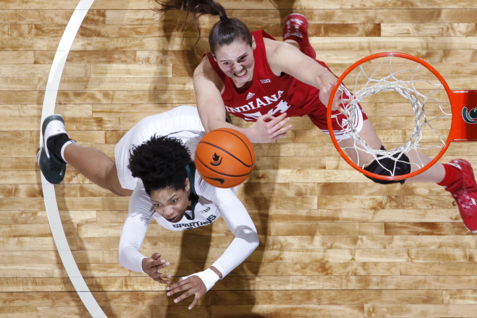 Michigan State's Isaline Alexander, left, and Indiana's Mackenzie Holmes vie for a rebound during the first half of an NCAA college basketball game Thursday, Dec. 29, 2022, in East Lansing, Mich. Michigan State won 83-78. (AP Photo/Al Goldis)