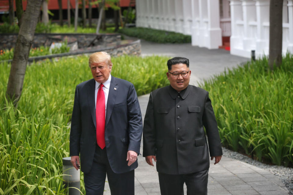 The two leaders take a stroll at their summit in Singapore (Picture: Getty)